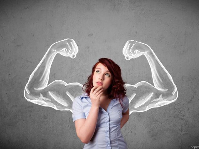 Young woman with strong muscled arms