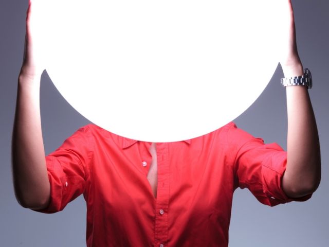 young woman covers imaginary ears with hands